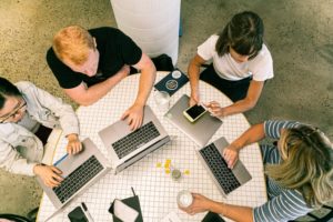 four people using laptop computers and smartphone 3277808
