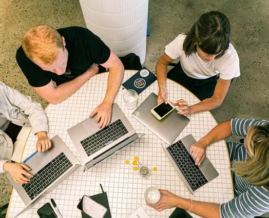 four people using laptop computers and smartphone 3277808