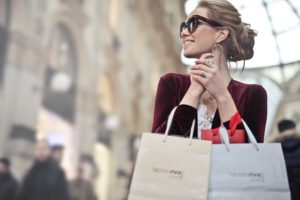 Woman Holding Two White And Beige Shopping Paper Bags In 974911