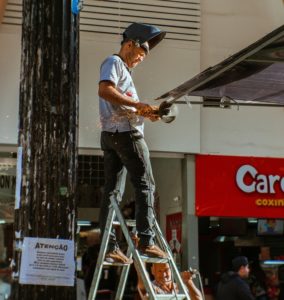 Person Using Angle Grinder Outdoors 2637051