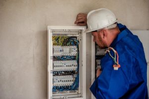 A person wearing a hard hat looking at a piece of art Description automatically generated with low confidence